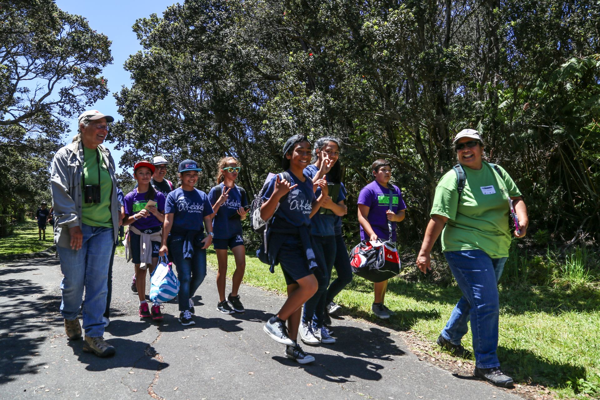 Students and their guides walk together on a park trail